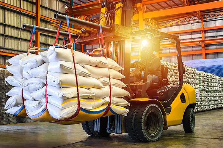 A forklift transporting bags.